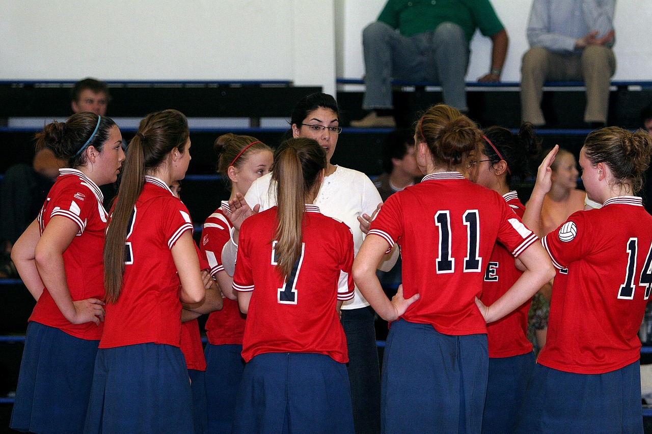 A coach giving encouragement and guidance to a young athlete