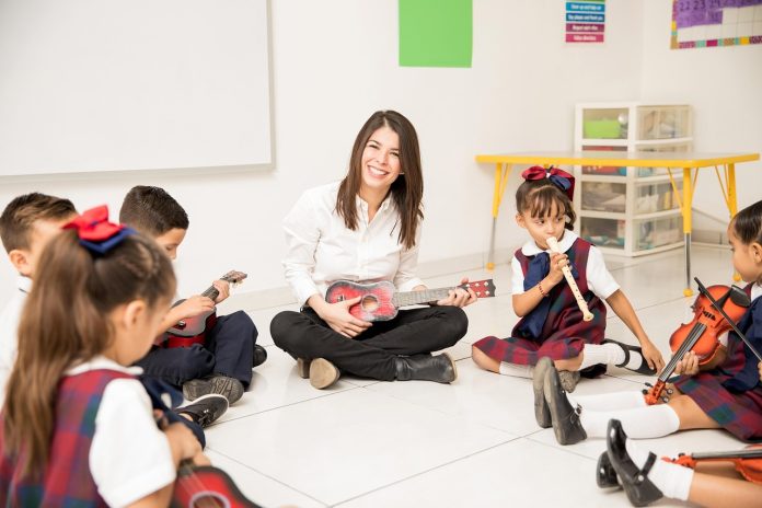 Young children in a classroom with their teacher