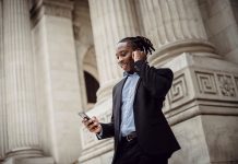 SBA 8(a) Certification: How Black-Owned Businesses Can Unlock Federal Contracts in 2026 Black entrepreneur on a phone call outside a federal building