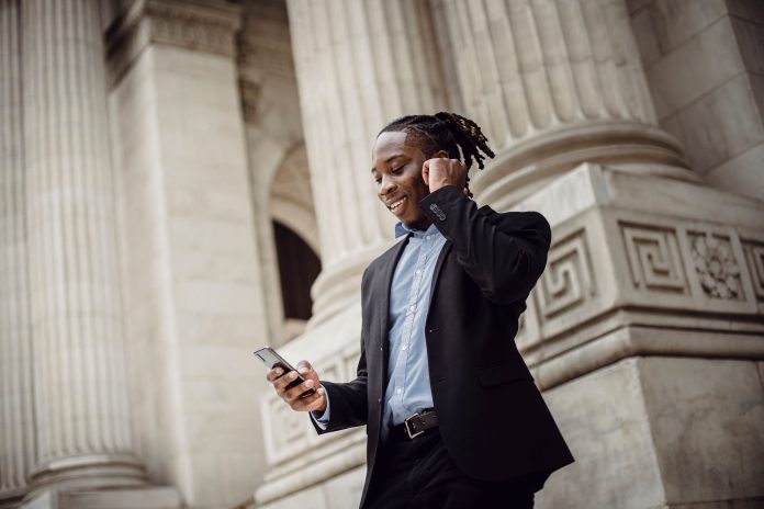 final_sba_featured.jpg Black entrepreneur on a phone call outside a federal building