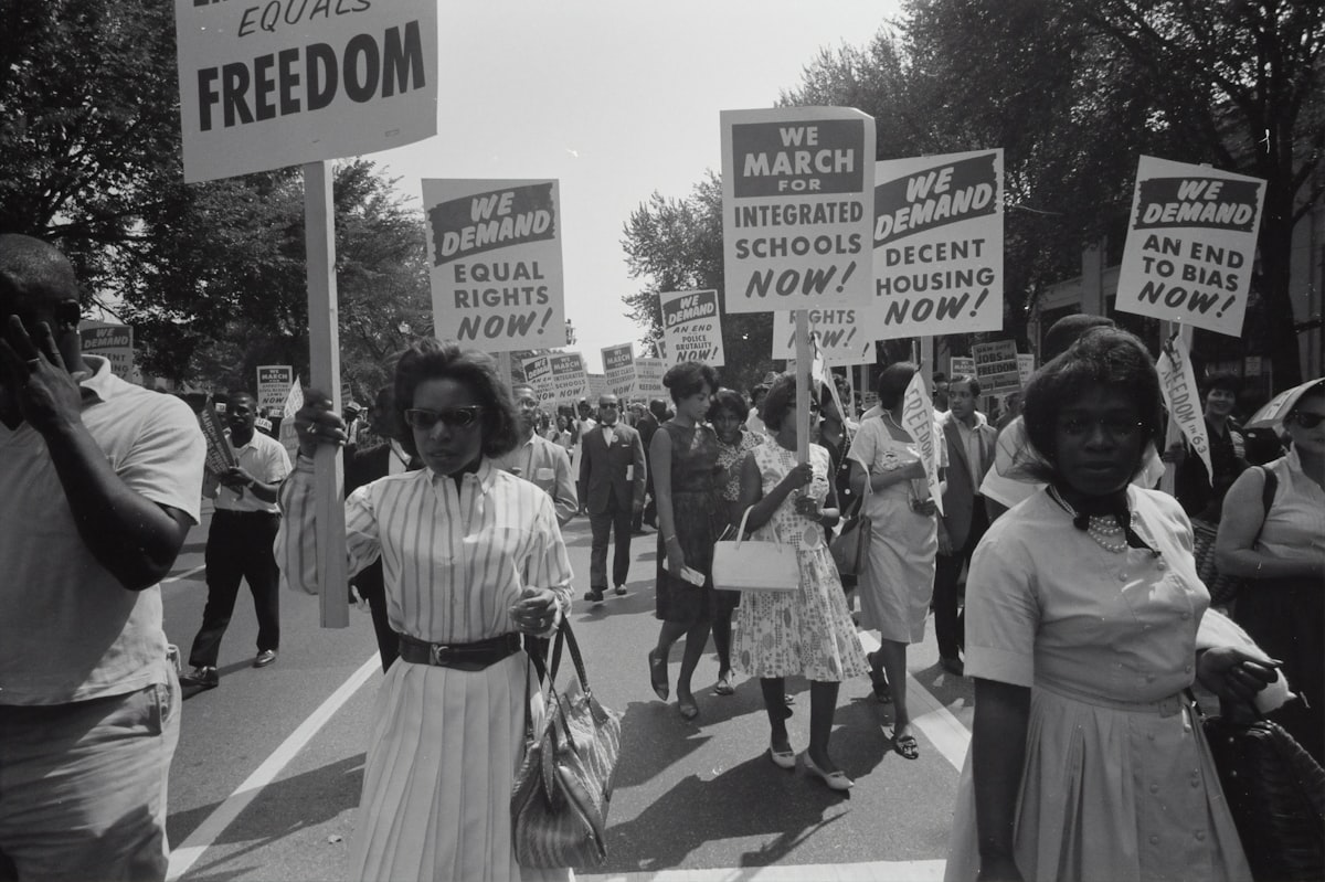 Historic civil rights era march with demonstrators carrying signs