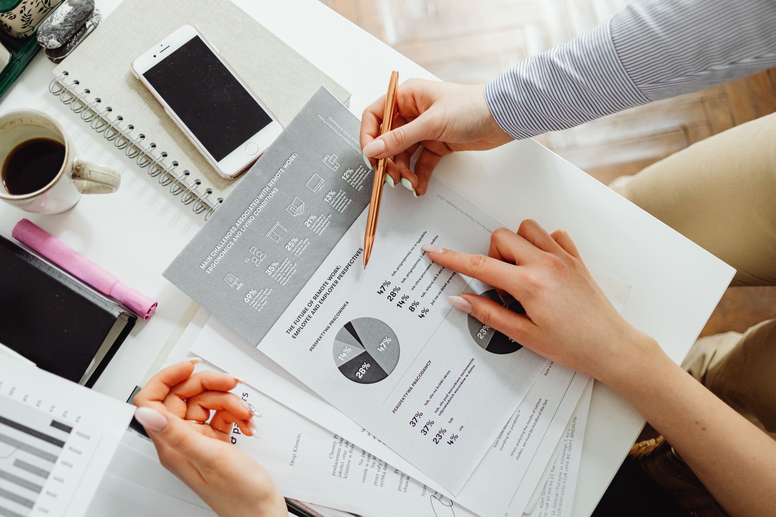 A team reviewing financial documents with charts and statistics in an office setting