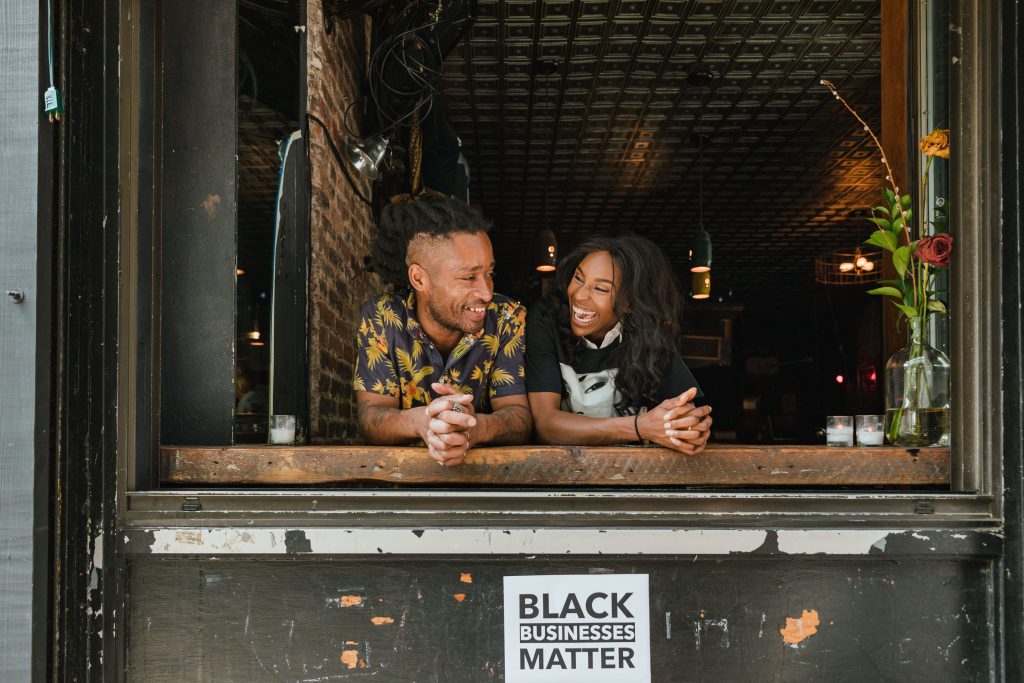 Black woman small business owner standing in her retail shop