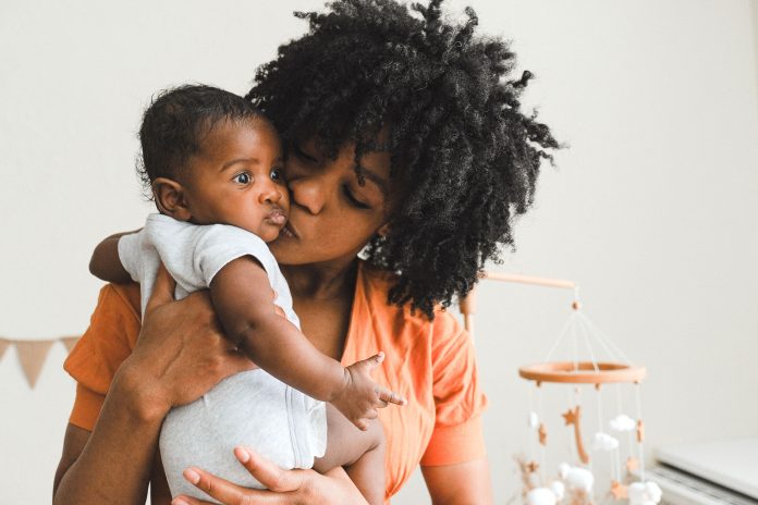 Black mother holding her newborn baby