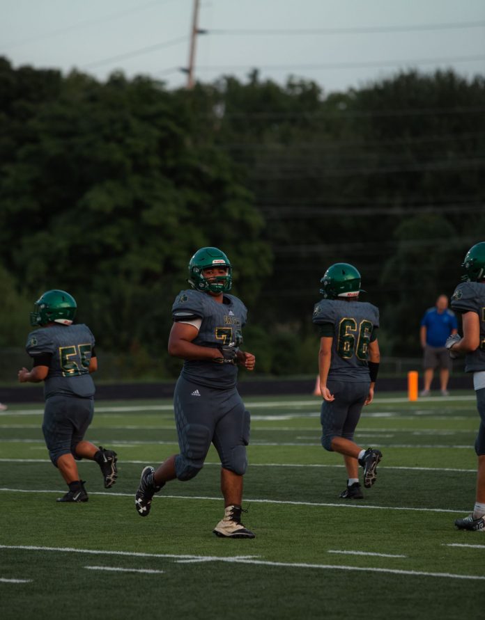 Football players in action on stadium field