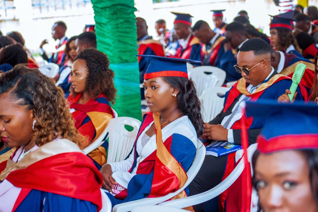 Students in caps and gowns celebrating together at a college graduation ceremony