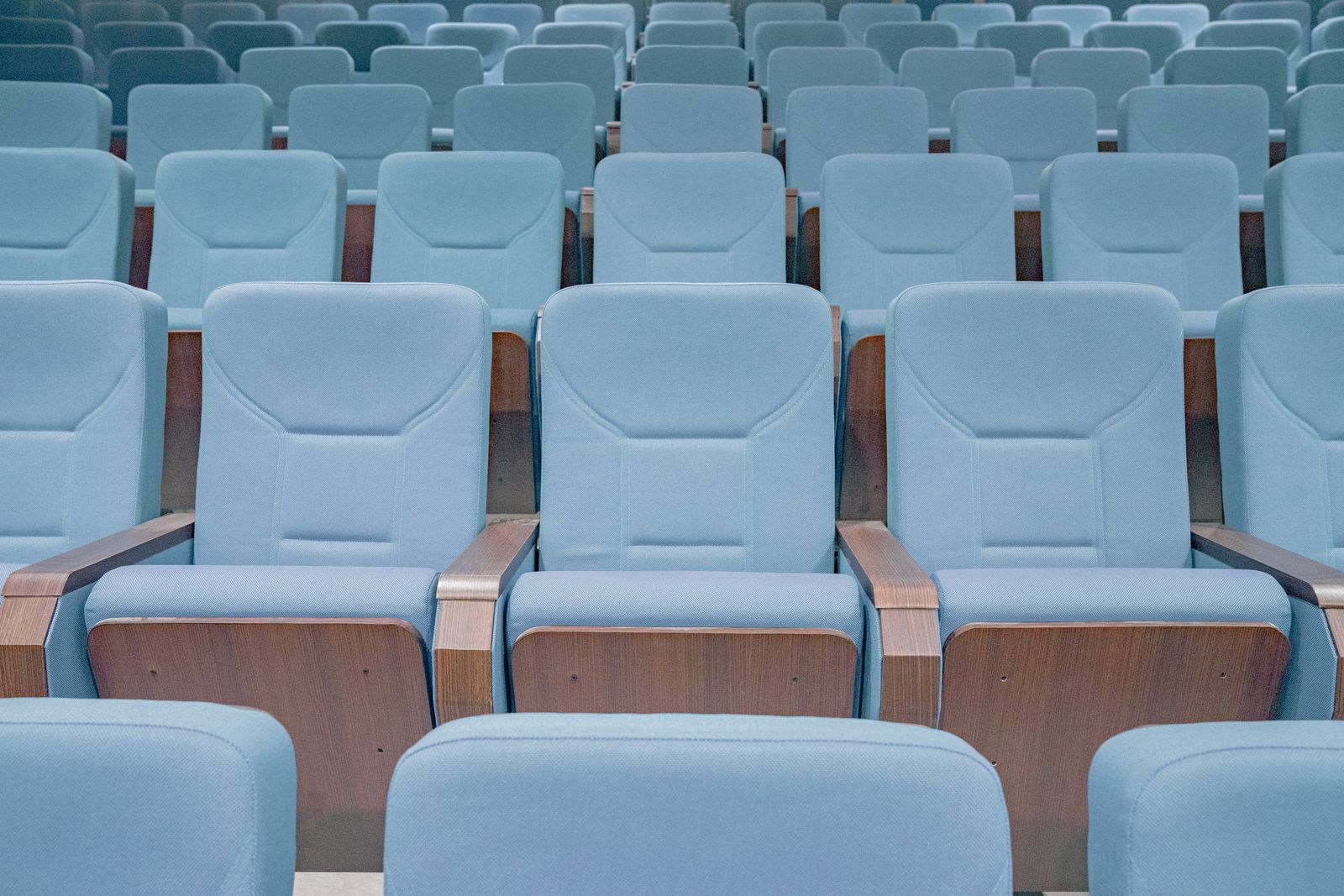 Rows of empty seats inside a modern movie theater auditorium