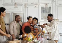 Health Starts on the Block: How Community Programs Fight Chronic Disease A joyful Black family gathering and embracing together in a kitchen