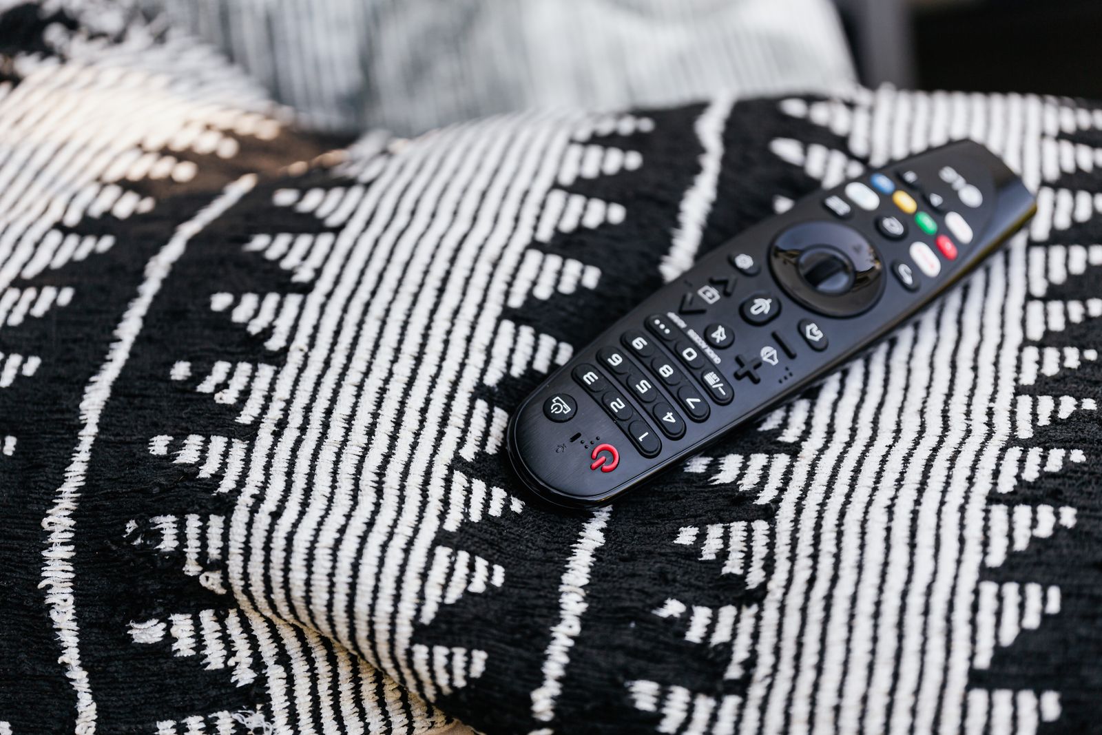 Close up of a hand holding a television remote control