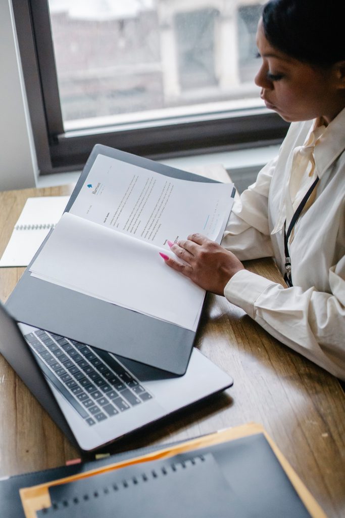 A Black entrepreneur reviewing business documents at a desk