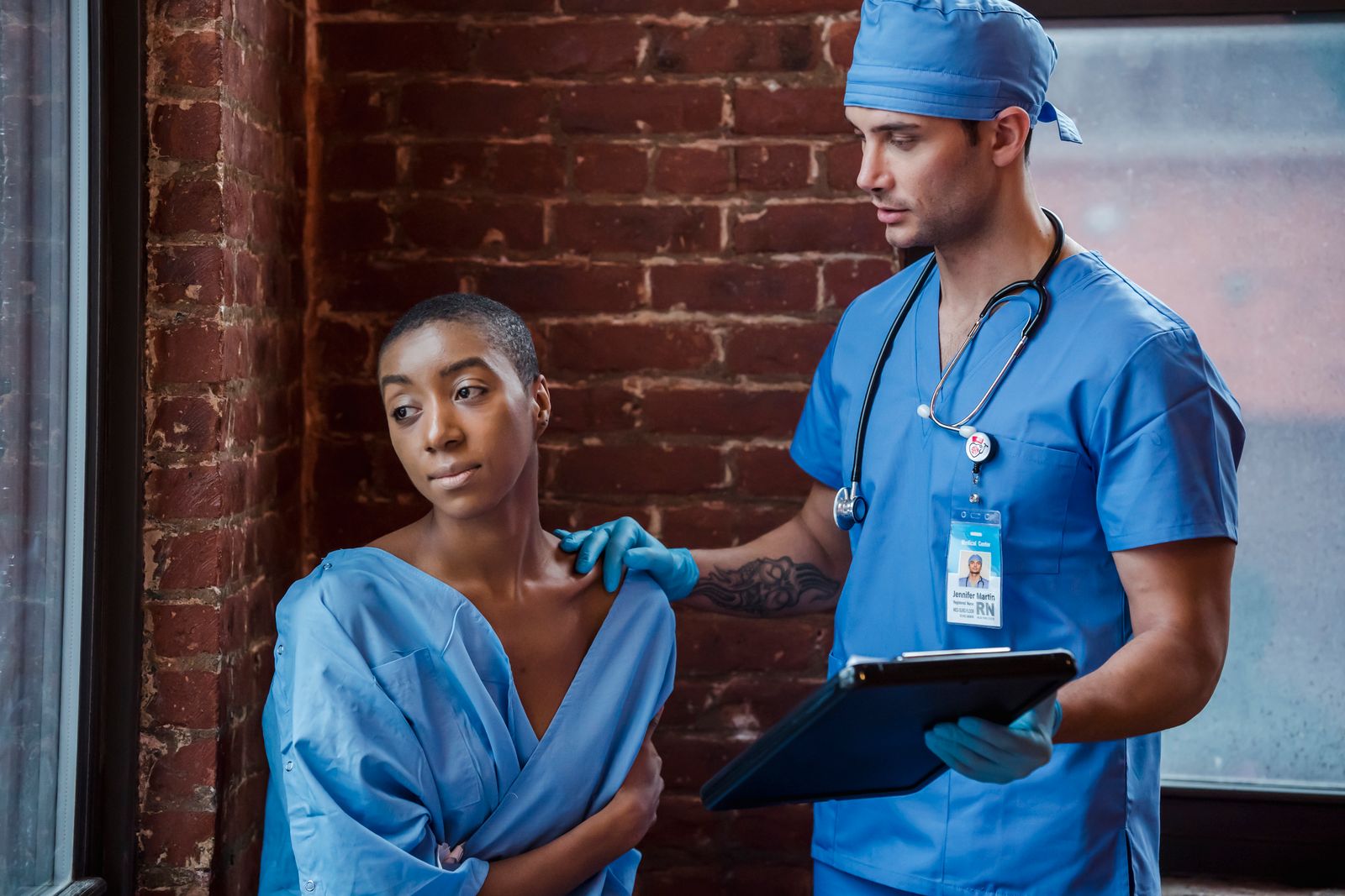 Doctor explaining diagnosis to patient in clinic hallway