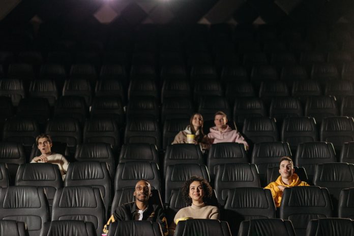 Audience watching a film in a movie theater