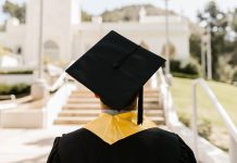 Big Student Loan Changes Took Effect July 1: What Black Borrowers Need to Do Now A college graduate in cap and gown standing outdoors.
