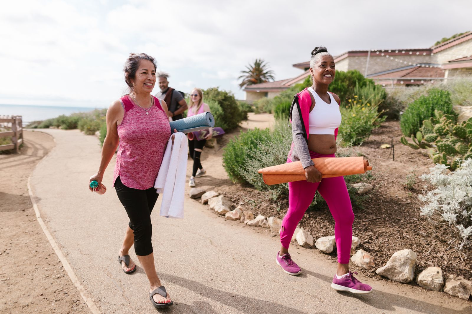 Women walking outdoors together during a morning fitness session
