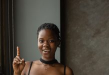 Fall 2026’s Must-Read Books by Black Authors, Led by Deesha Philyaw’s Debut Novel A Black woman reading a book, representing a fall 2026 reading list of Black authors