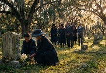 1906 Atlanta Race Massacre at 120: How to Join the Remembrance Black grandmother and teenage grandson laying white roses at a weathered marker in an old cemetery