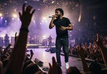 BET Hip Hop Awards 2026 Aren’t Happening. Here’s What Is Instead A Black rapper performing on a concert stage under purple and gold lights as the crowd raises their hands