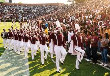 HBCU Football 2026 at Midseason: Teams to Watch and Big October Games A Black college marching band in maroon and white uniforms high-steps along a football sideline as fans cheer on a sunny fall afternoon